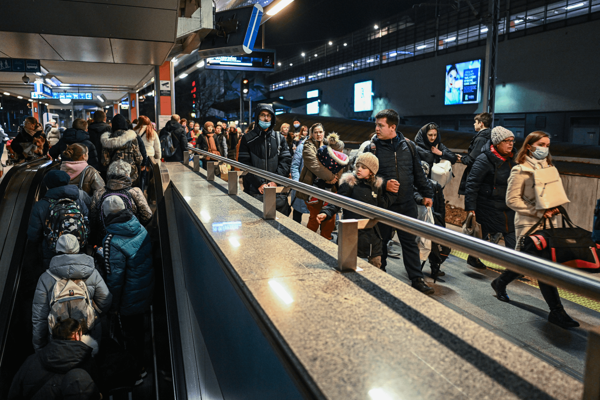 UKRAINIANS-WALK-TOWARDS-A-HUMANITARIAN-TRAIN-TO-RELOCATE-REFUGEES-TO-BERLIN